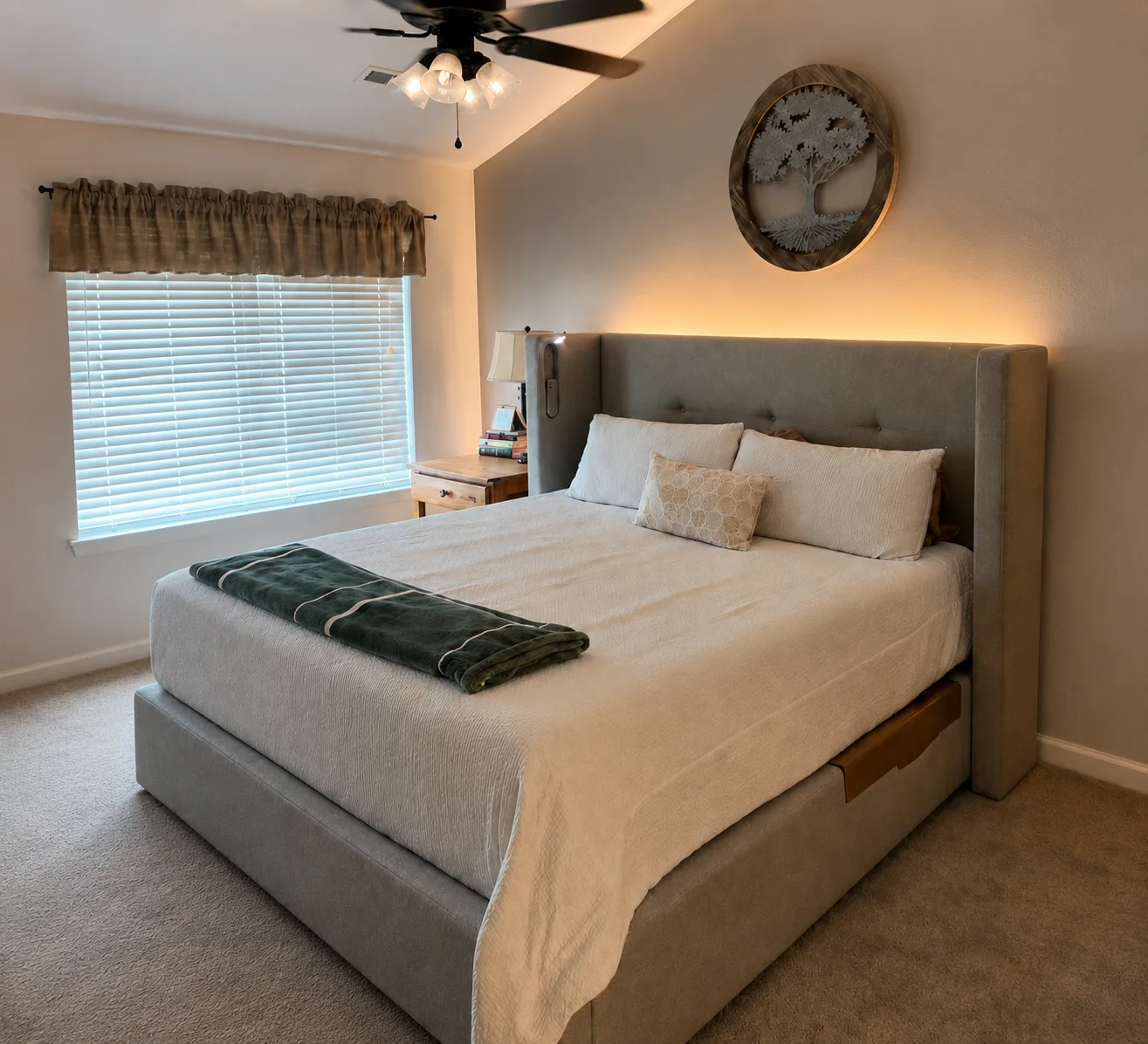 Warm neutral customer bedroom with upholstered bed and layered bedding